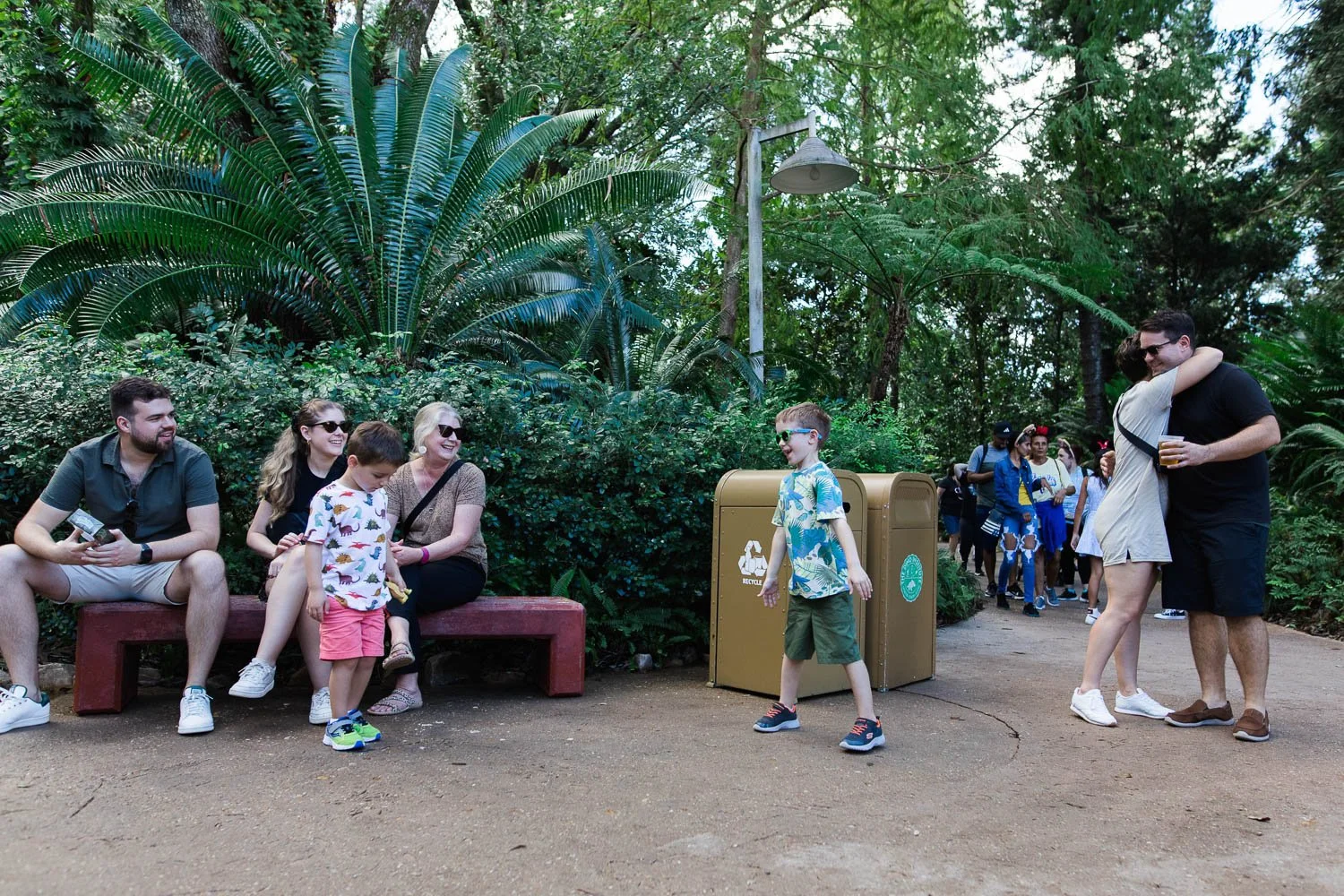 Family waits for the rest of their party at the Dinosaur attraction exit at the Animal Kingdom.