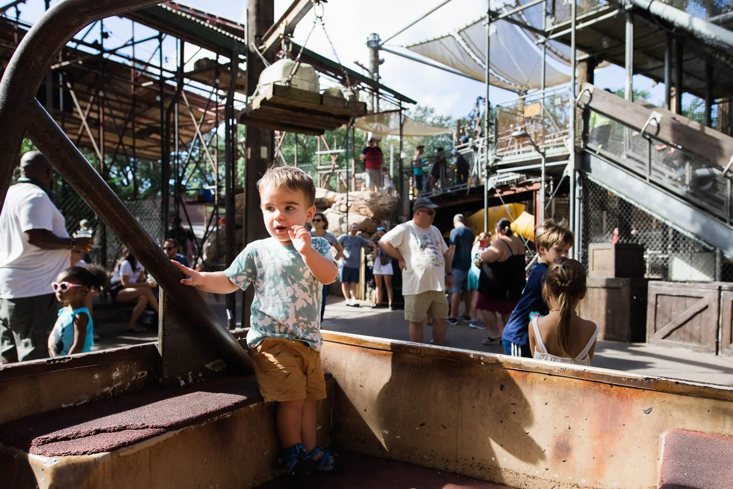 Little boy plays on play truck at the Boneyard in the Animal Kingdom.