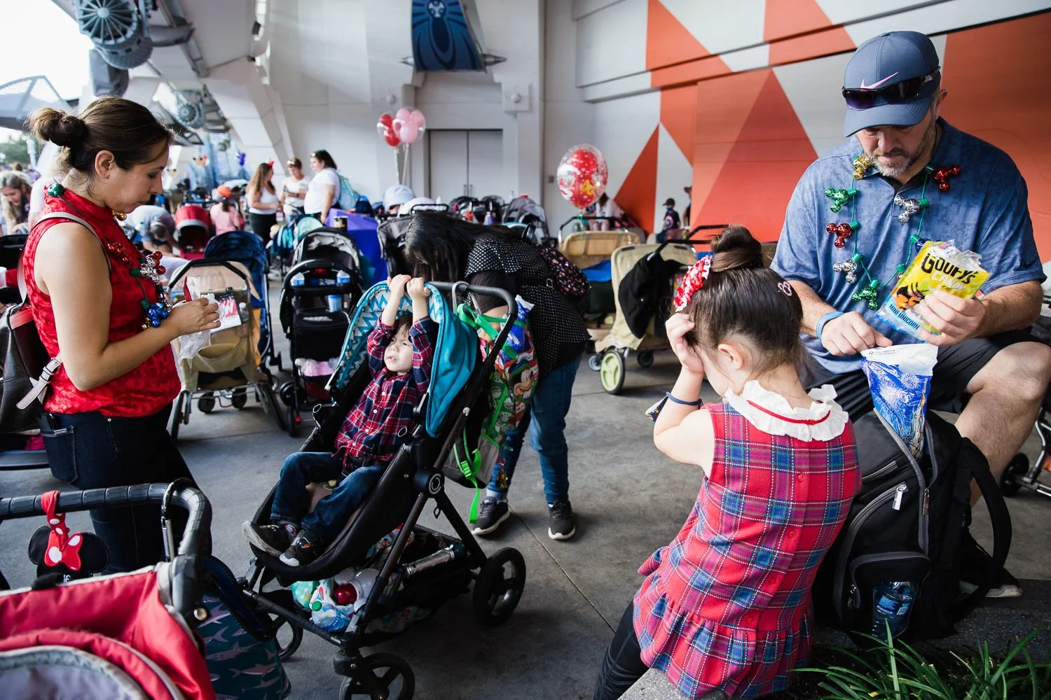 Family takes a break in the stroller parking area of Tomorrowland.