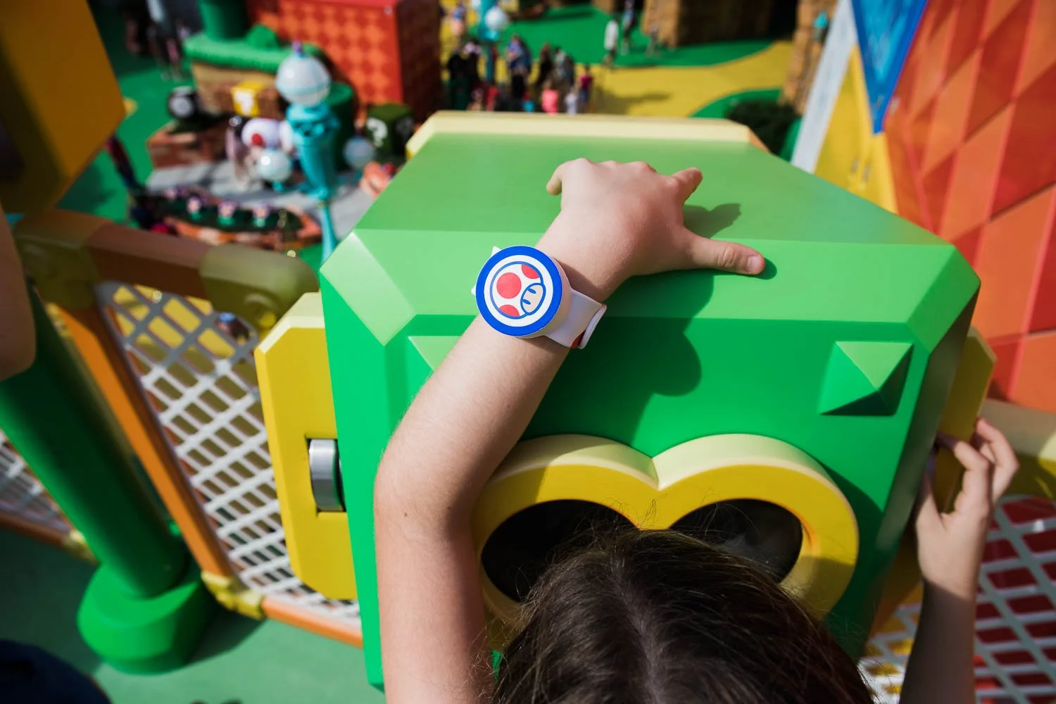 Up close detail photo of a Toad themed power up band in Super Nintendo World.