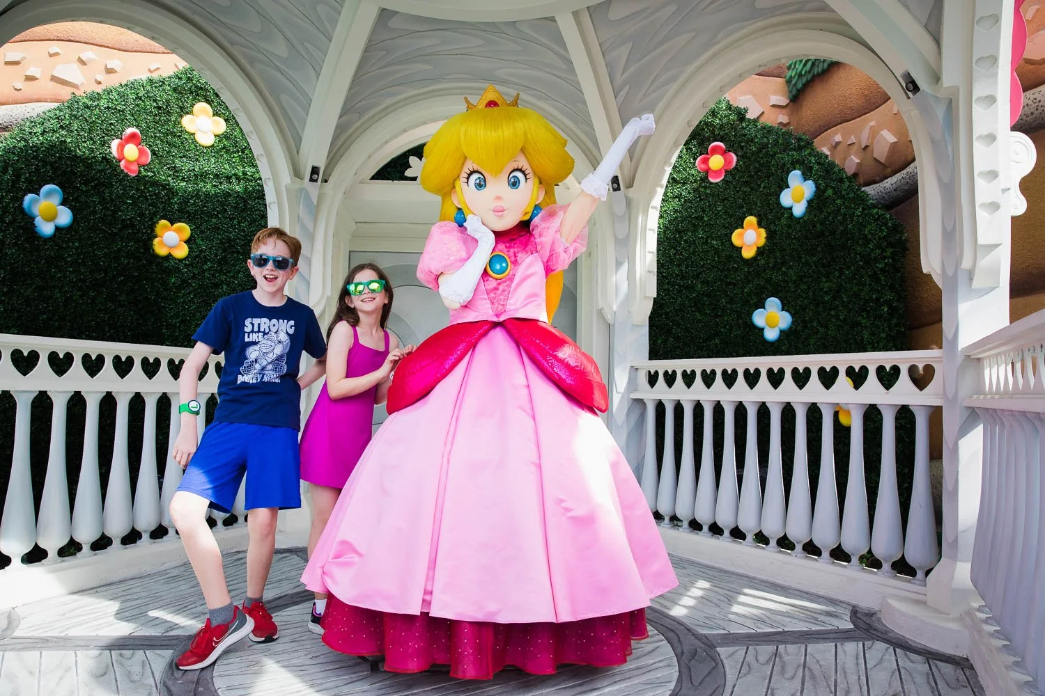 Kids meet Princess Peach at Super Nintendo World in Epic Universe.