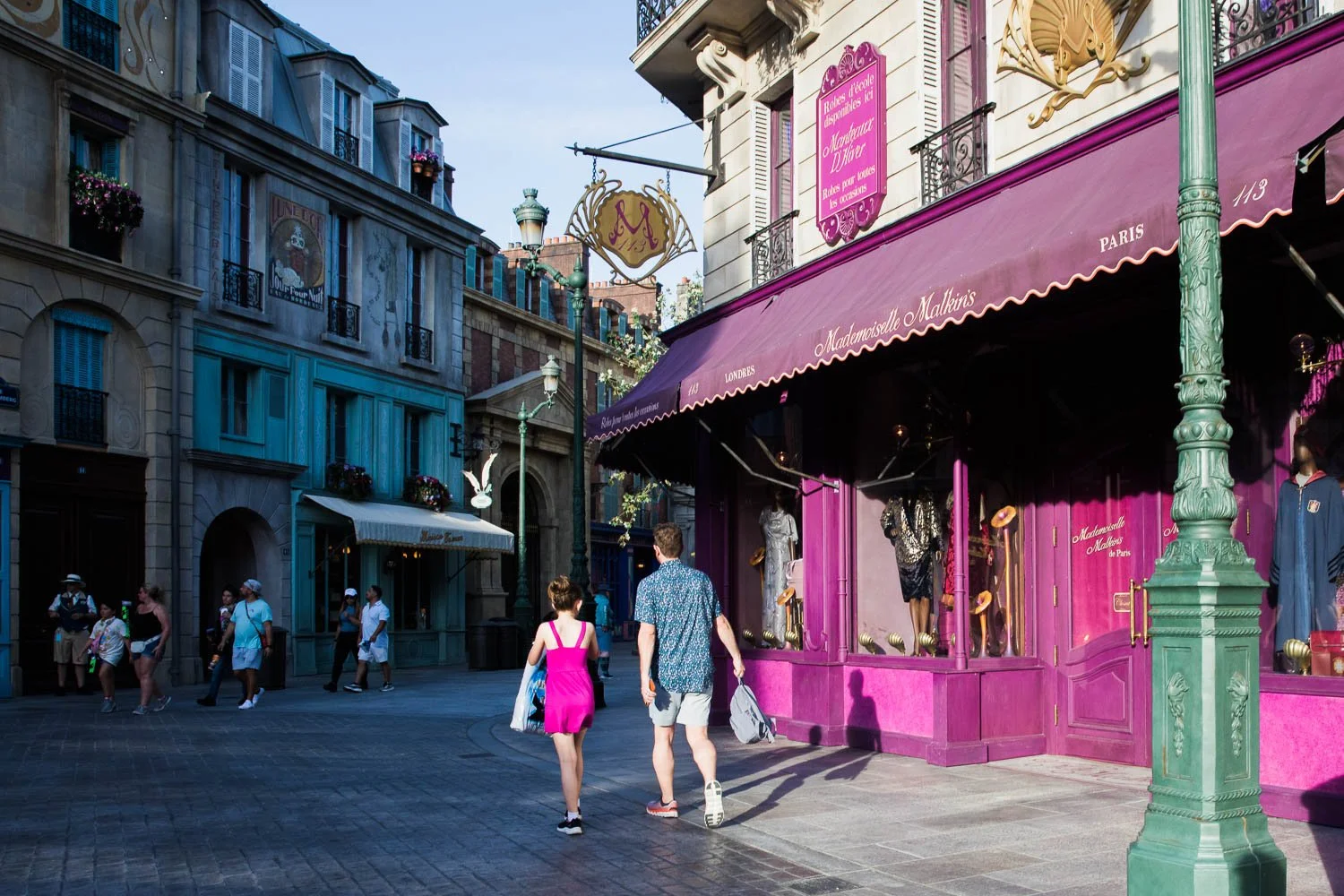 Father and daughter walk through the Wizarding World of Harry Potter.