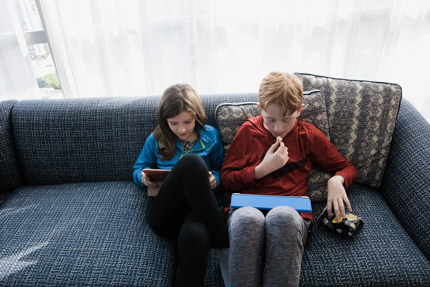 Kids play on iPads at Hilton Vancouver Downtown.