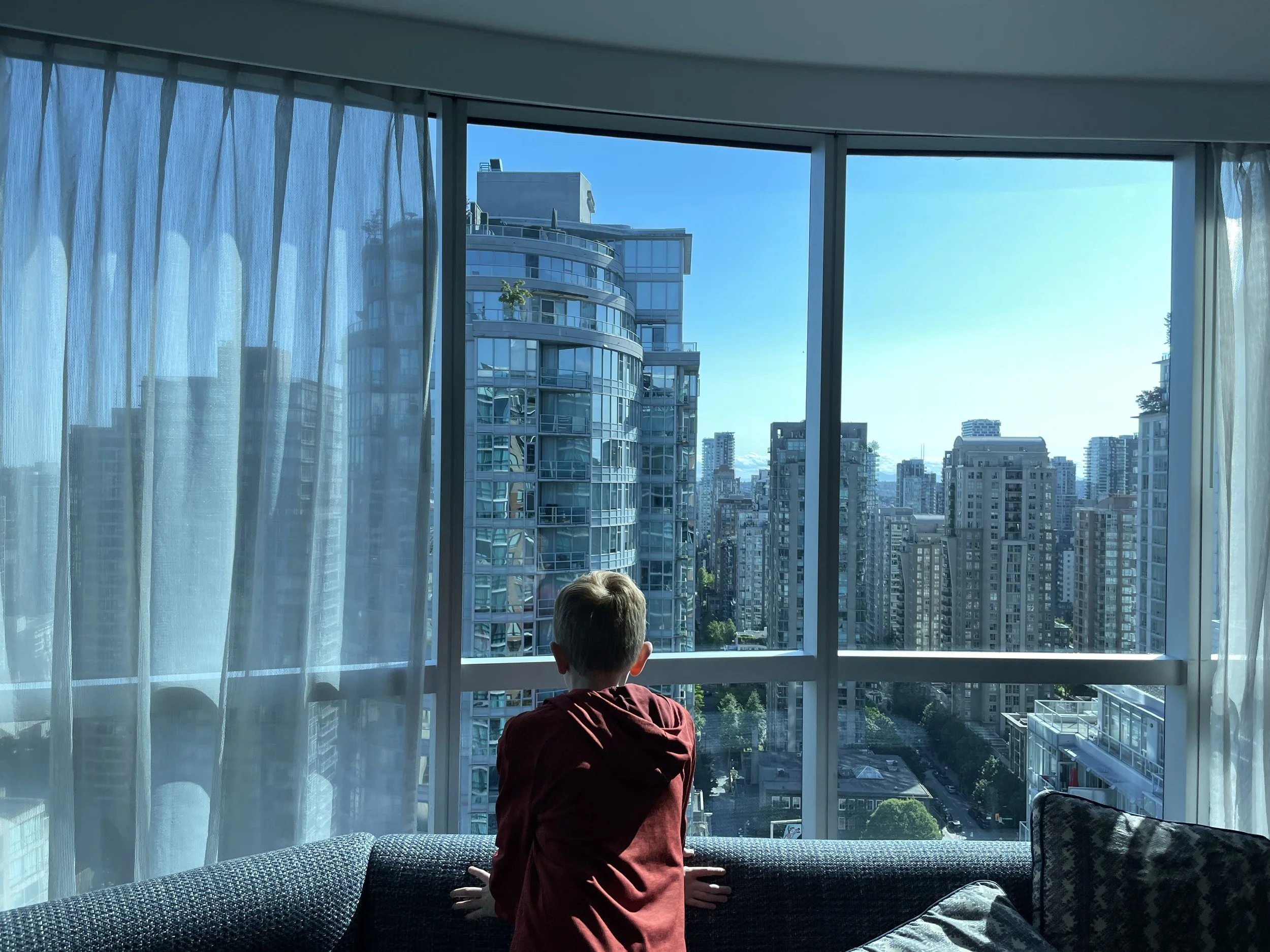 Tween looks out at the Vancouver skyline from Hilton Downtown Vancouver.