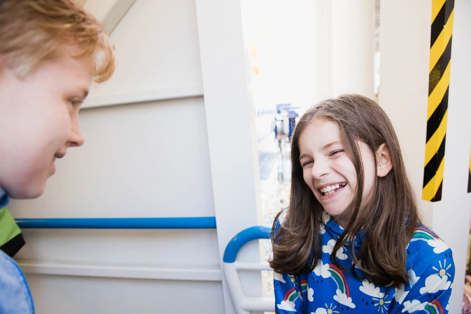 Girl laughs while walking up the gangway to board the Disney Wonder.