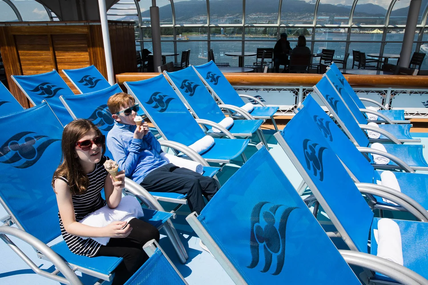Kids eating ice cream in front of the funnel vision on the Disney Wonder.