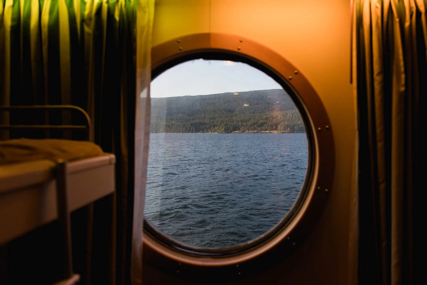 View of the ocean from the porthole of an oceanview stateroom on the Disney Wonder.