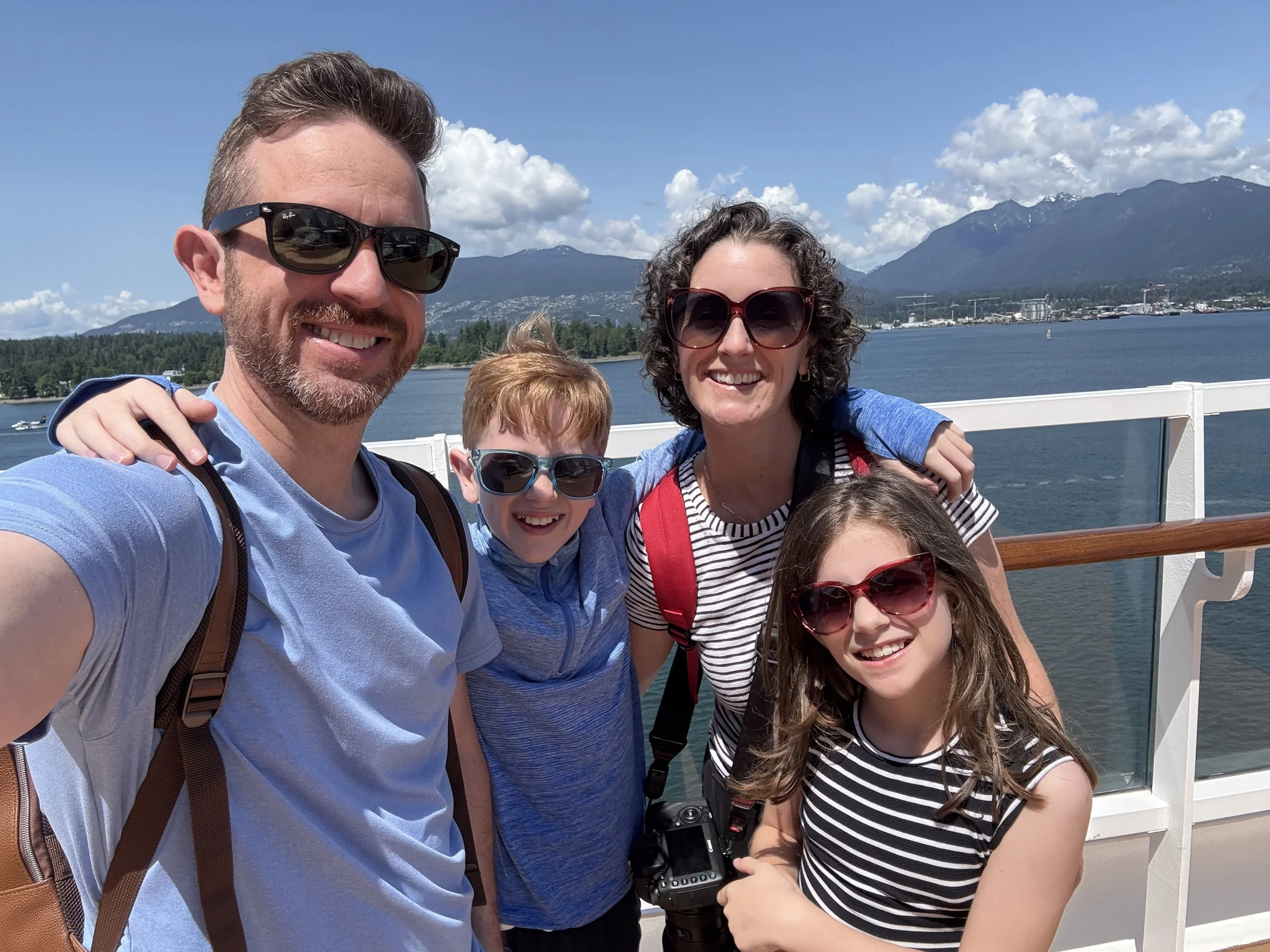 Family selfie in on the Disney Wonder with Vancouver in the background.