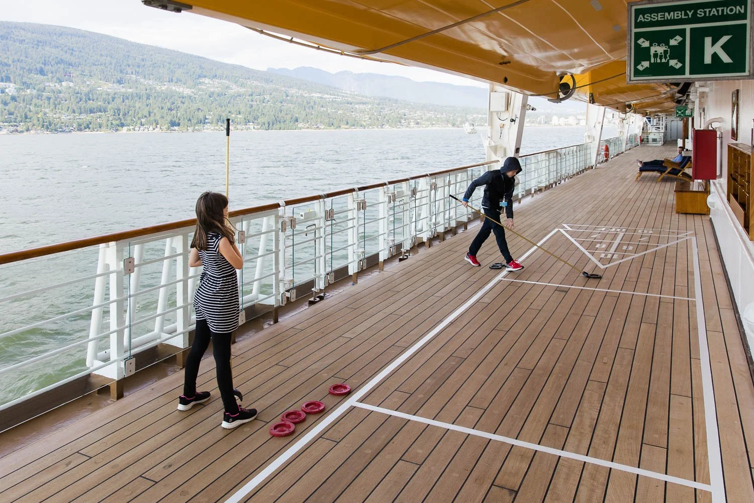 Kids playing shuffleboard on deck 4 of the Disney Wonder.