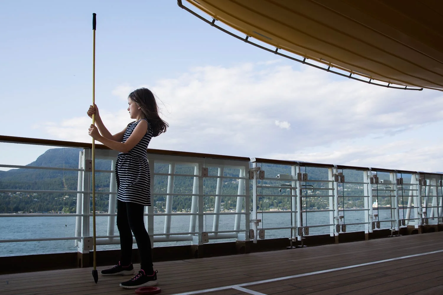 Girl looks out at the ocean on deck 4 of the Disney Wonder.