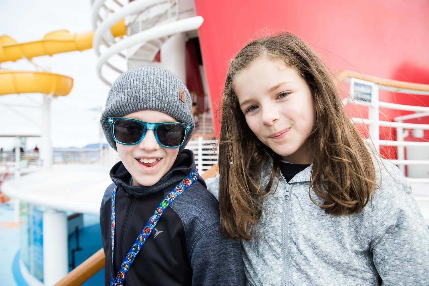 Portrait of siblings in front of the Mickey funnel on the Disney Wonder in Alaska.