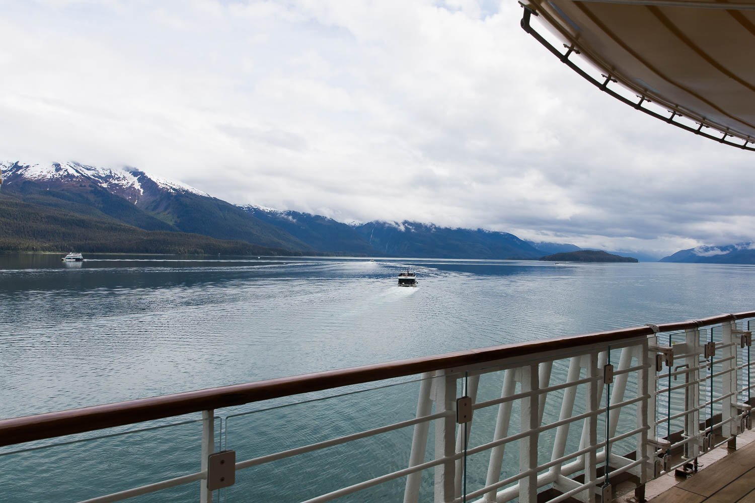 Glacier Explorer boat speeds away from the Disney Wonder in Endicott Arm Alaska.