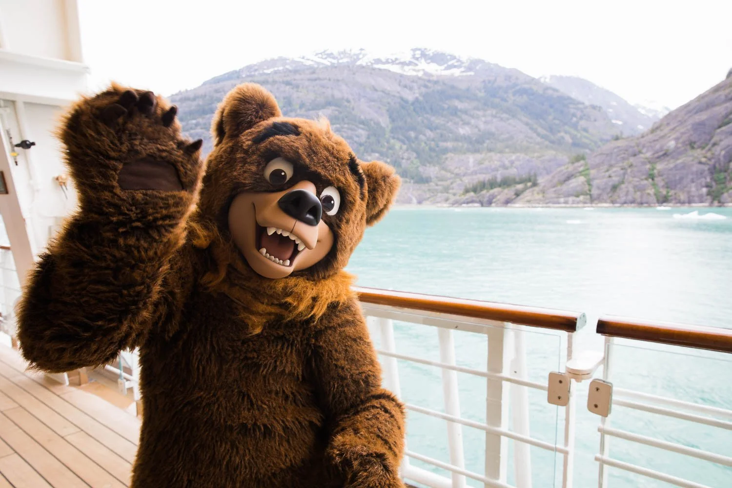 Koda waves hello to guests on deck four of the Disney Wonder in Alaska.