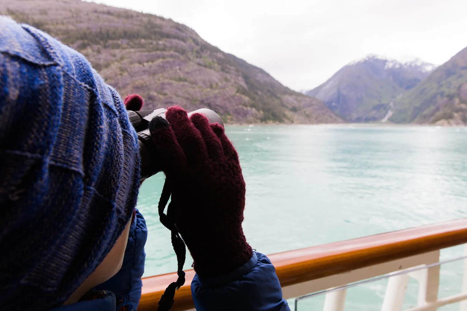 Teen boy looks out over the Stikine Icecap in Alaska, from a cruise ship.