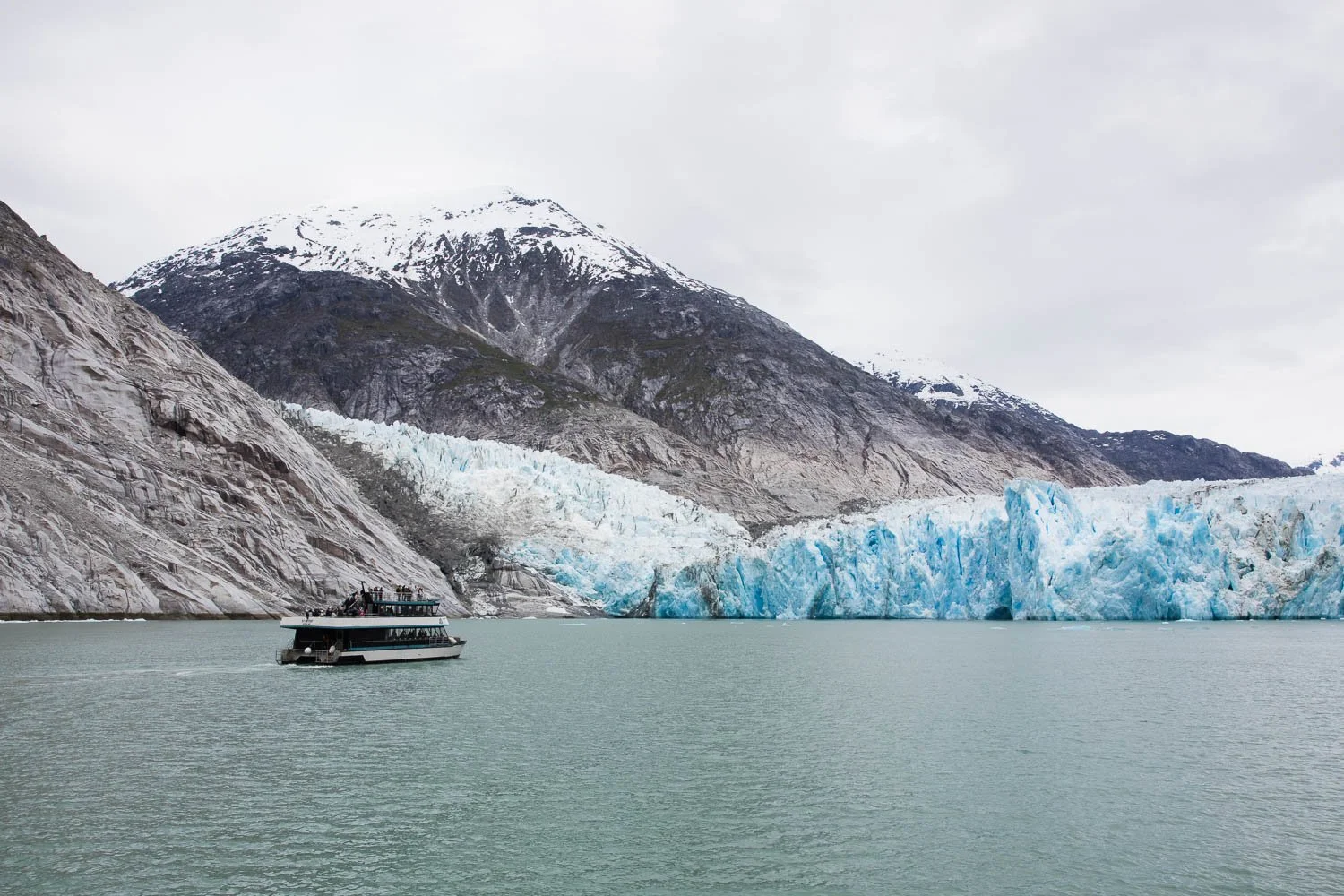 Boat is dwarfed by the size of Dawes Glacier.