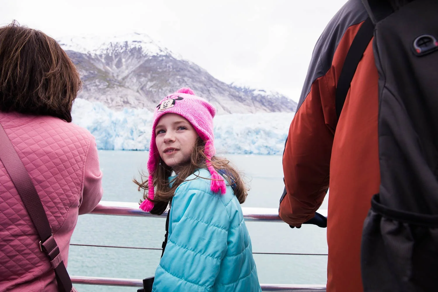 Girl looks out at glaciers in Alaska.