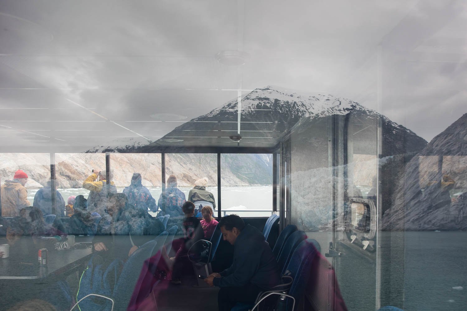Looking through glass windows at Alaskan wilderness.