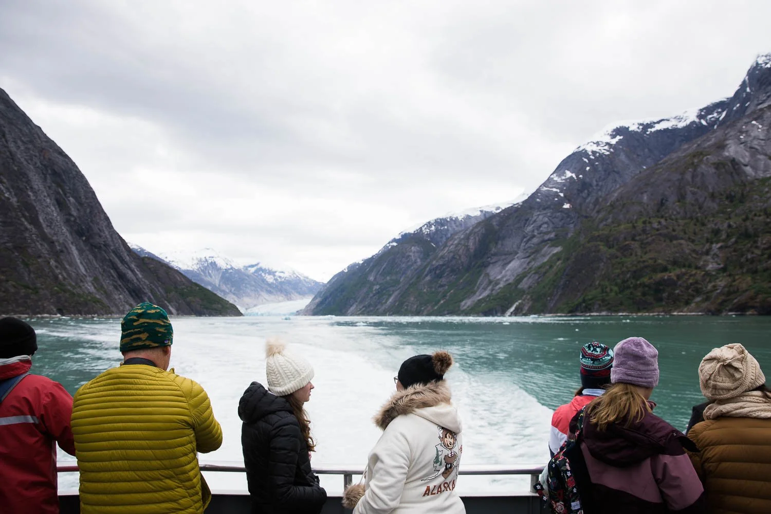 Tourists look out over Alaskan glacier and fjord in Endicott Arm.
