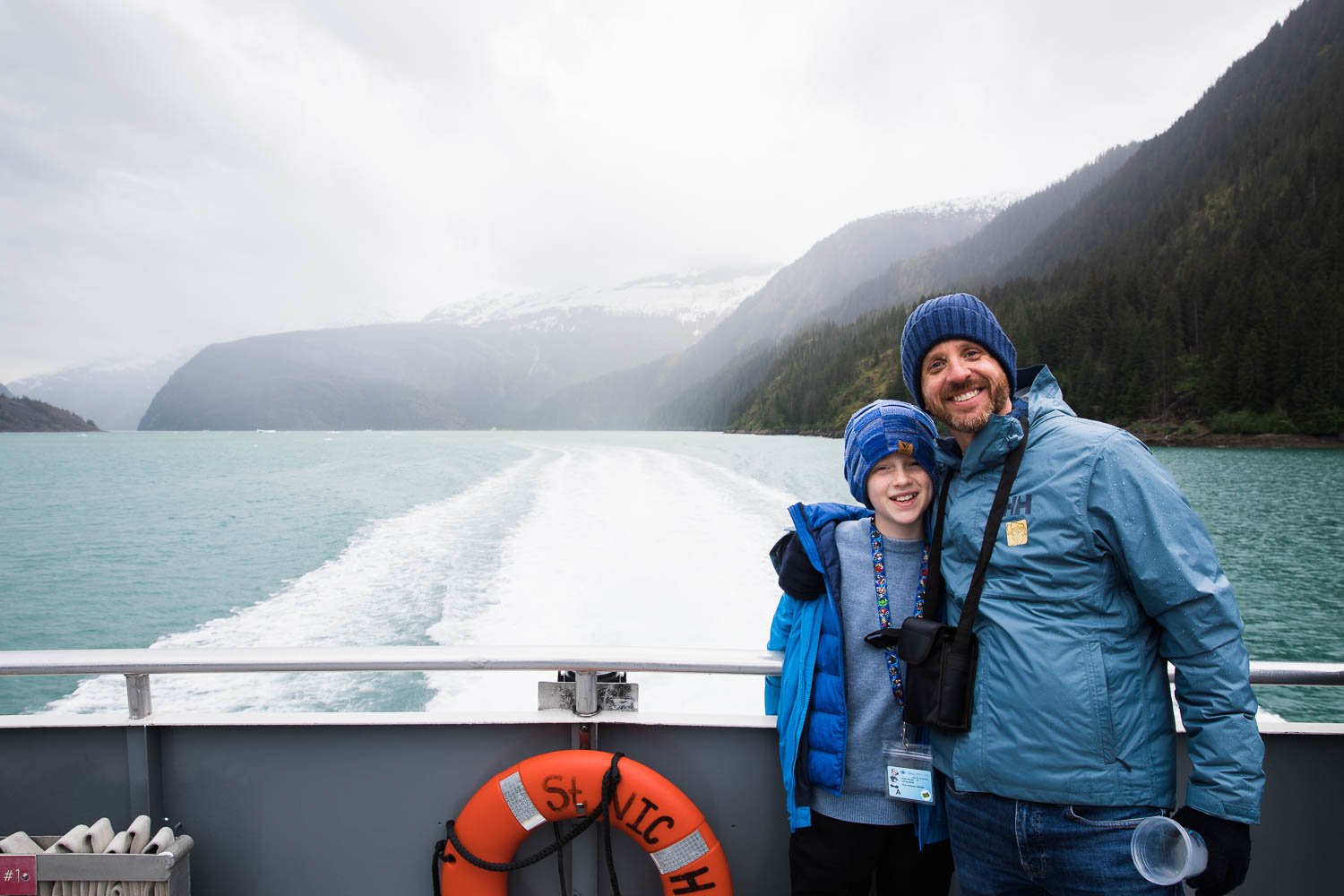 Father and son pose for a photo in Alaska.