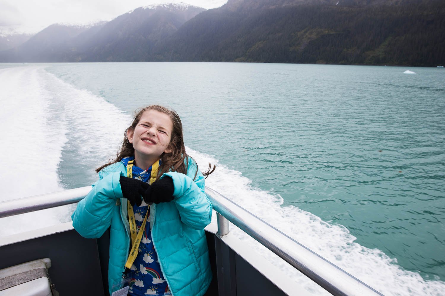 Girl laughs on a boat in Alaska.
