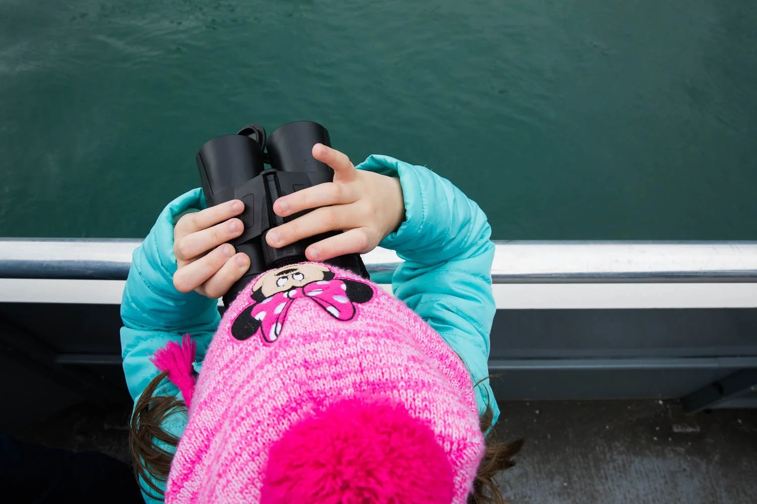 Photo of a girl and her binoculars in Alaska.