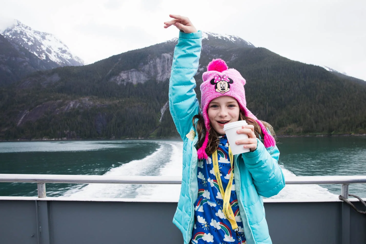 Girl dances on the back of a boat excursion in Alaska.