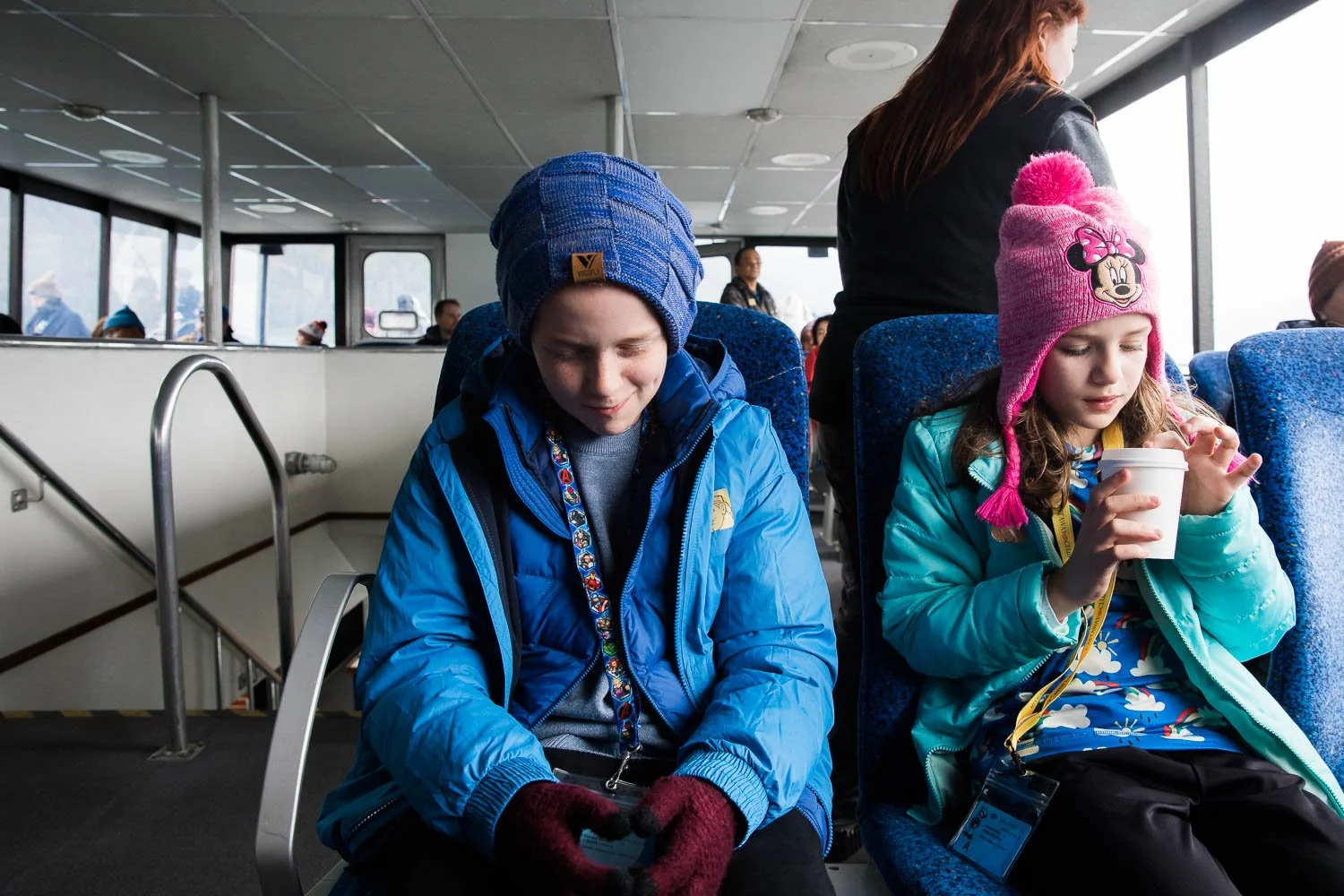 Kids sit in the interior of a boat in Alaska.