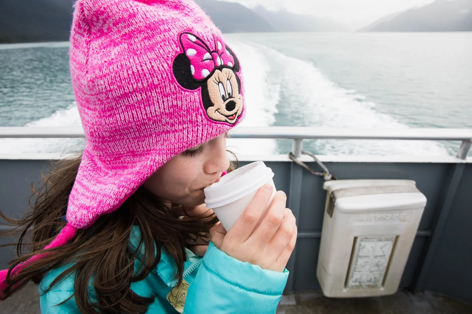 Girl sips on hot cocoa in Alaska.