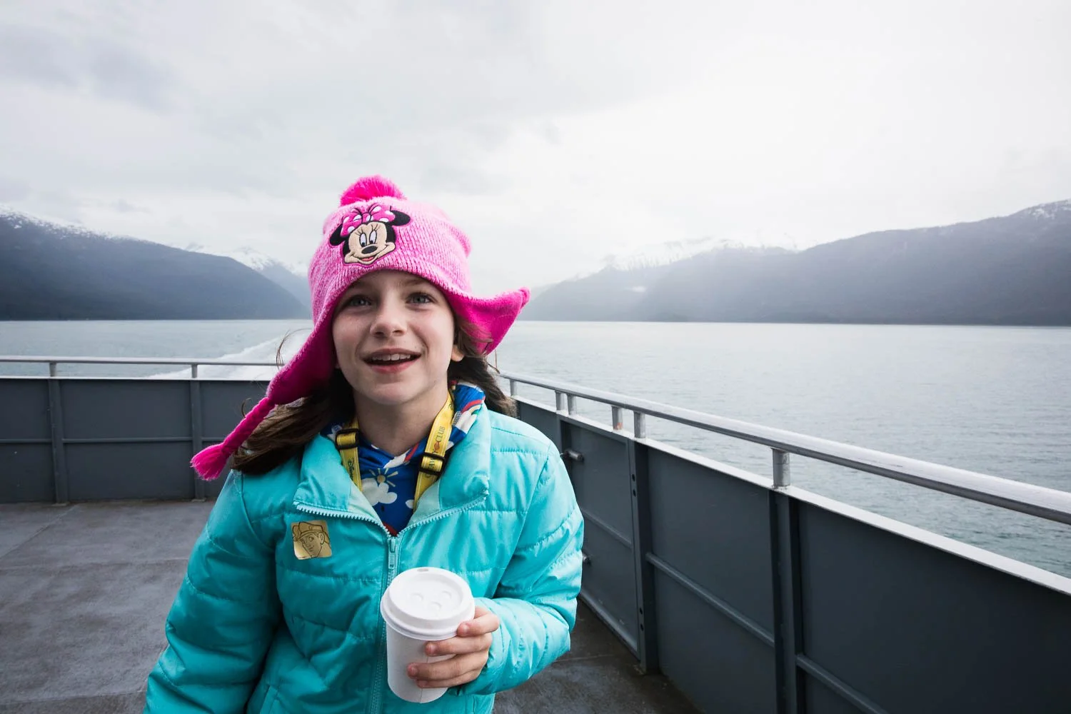 Girl enjoys hot cocoa in Alaska.