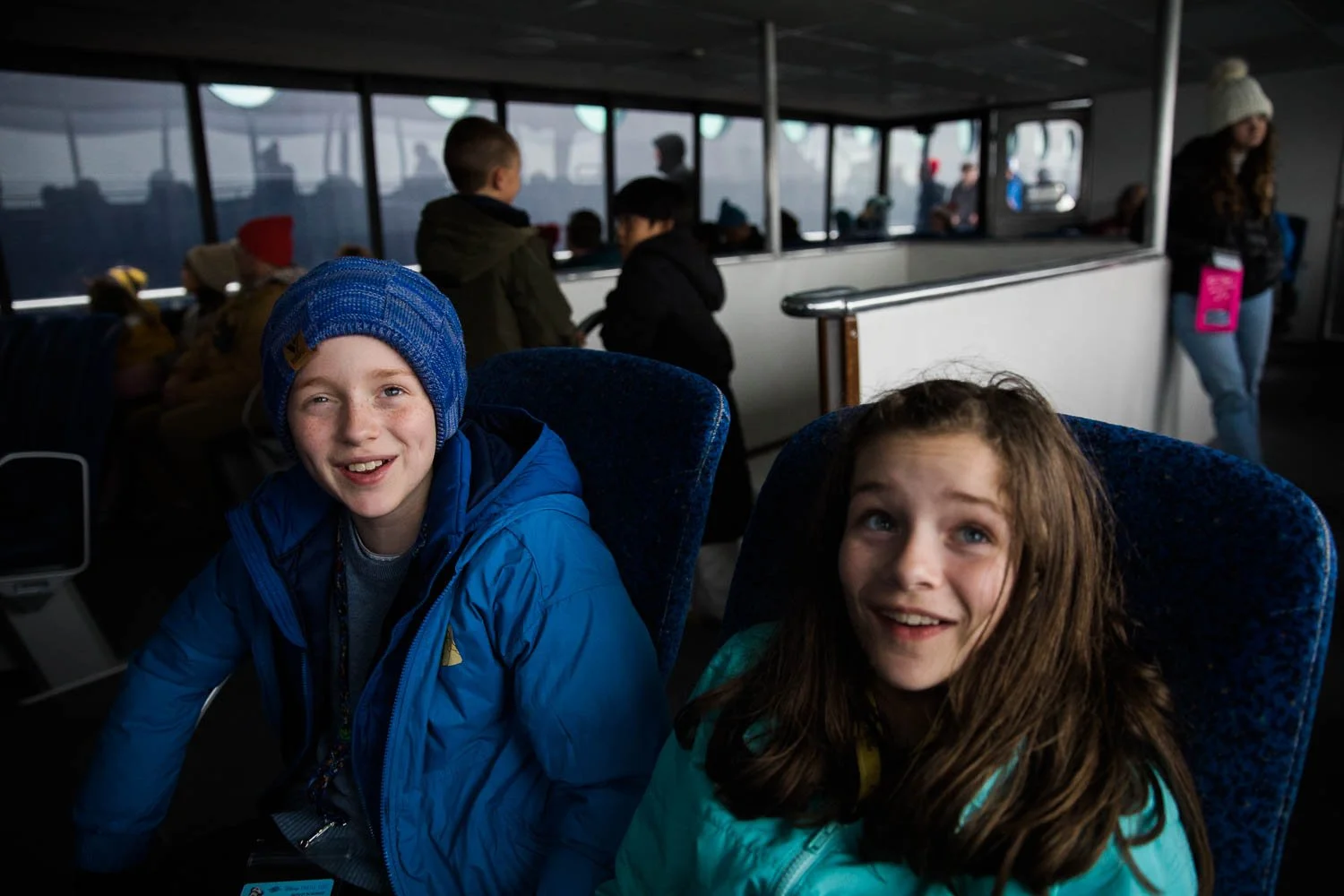 Siblings sit on a boat in Alaska.