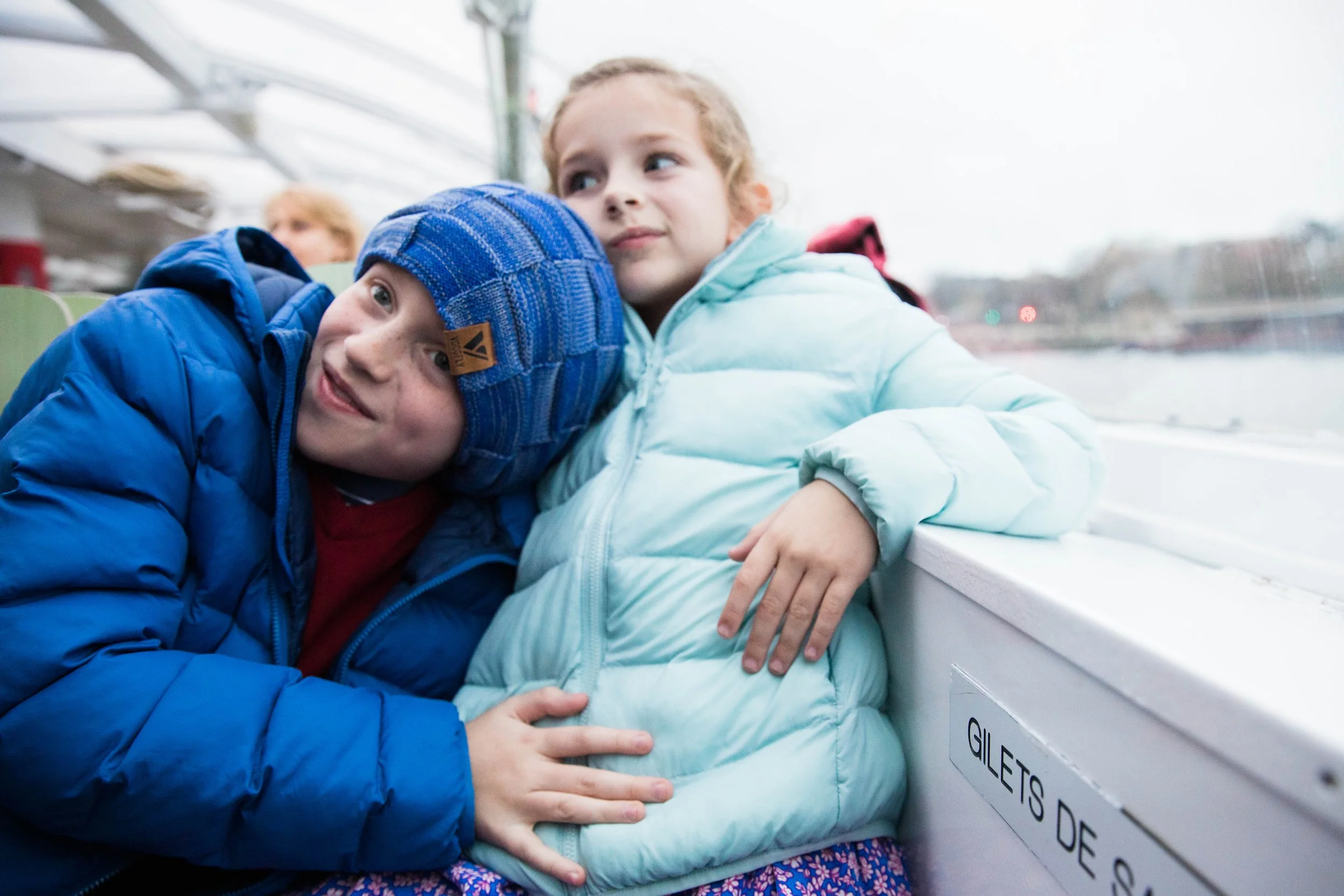 Siblings on a boat on the Seine in Paris.