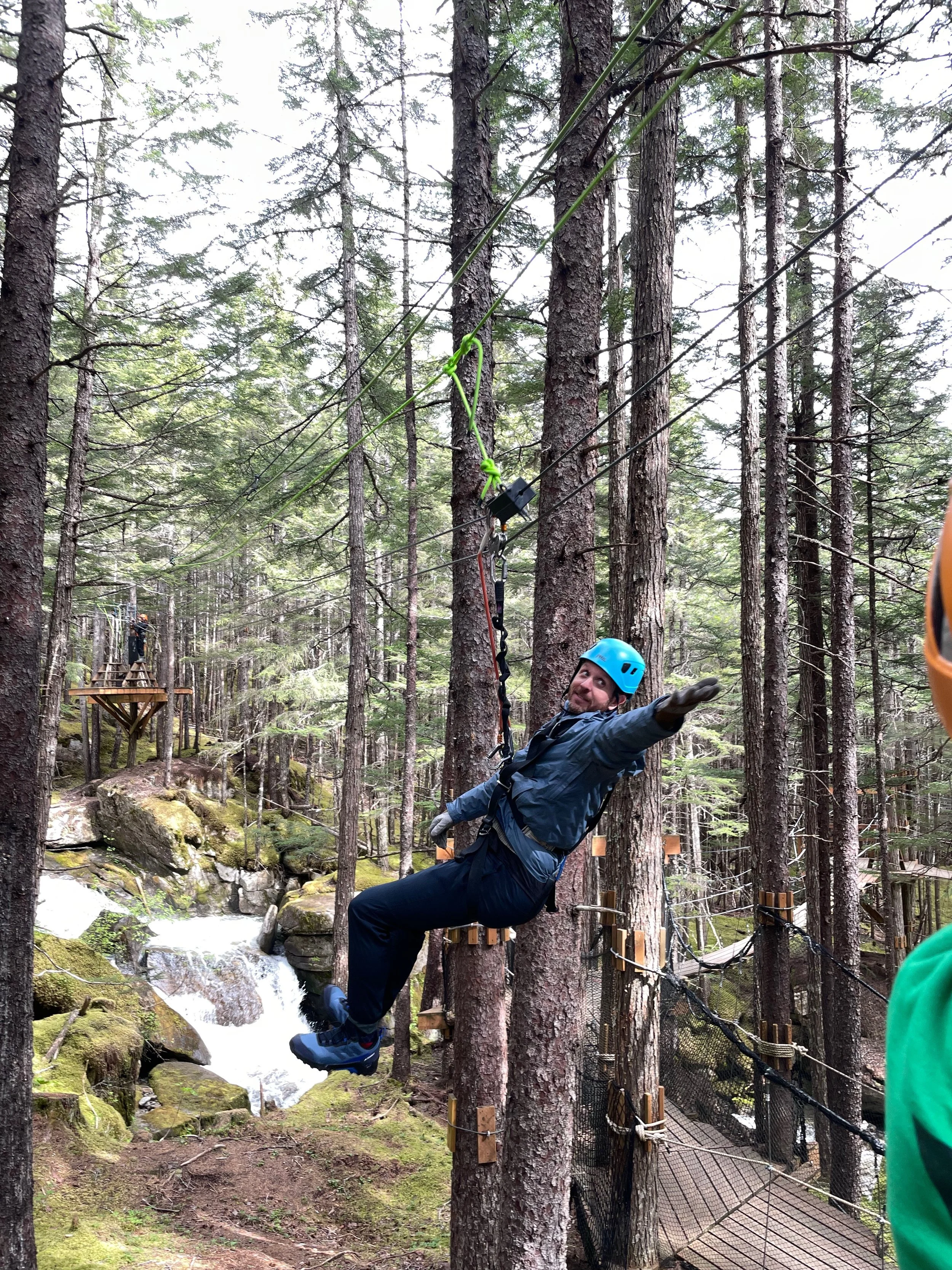 Man zip lines in Skagway, Alaska At Grizzly Falls.