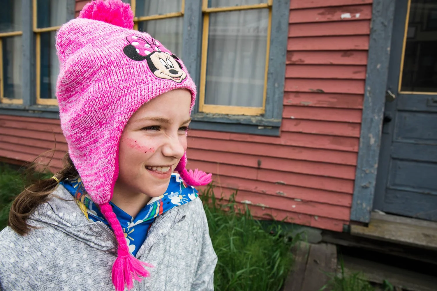 Girl smiles as she walks through Skagway, Alaska.