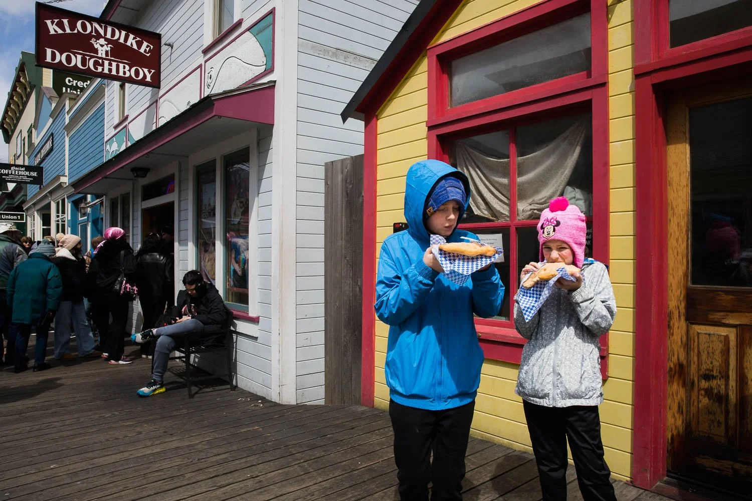 Kids enjoy a doughboy from the Klondike Doughboy in Skagway, Alaska.