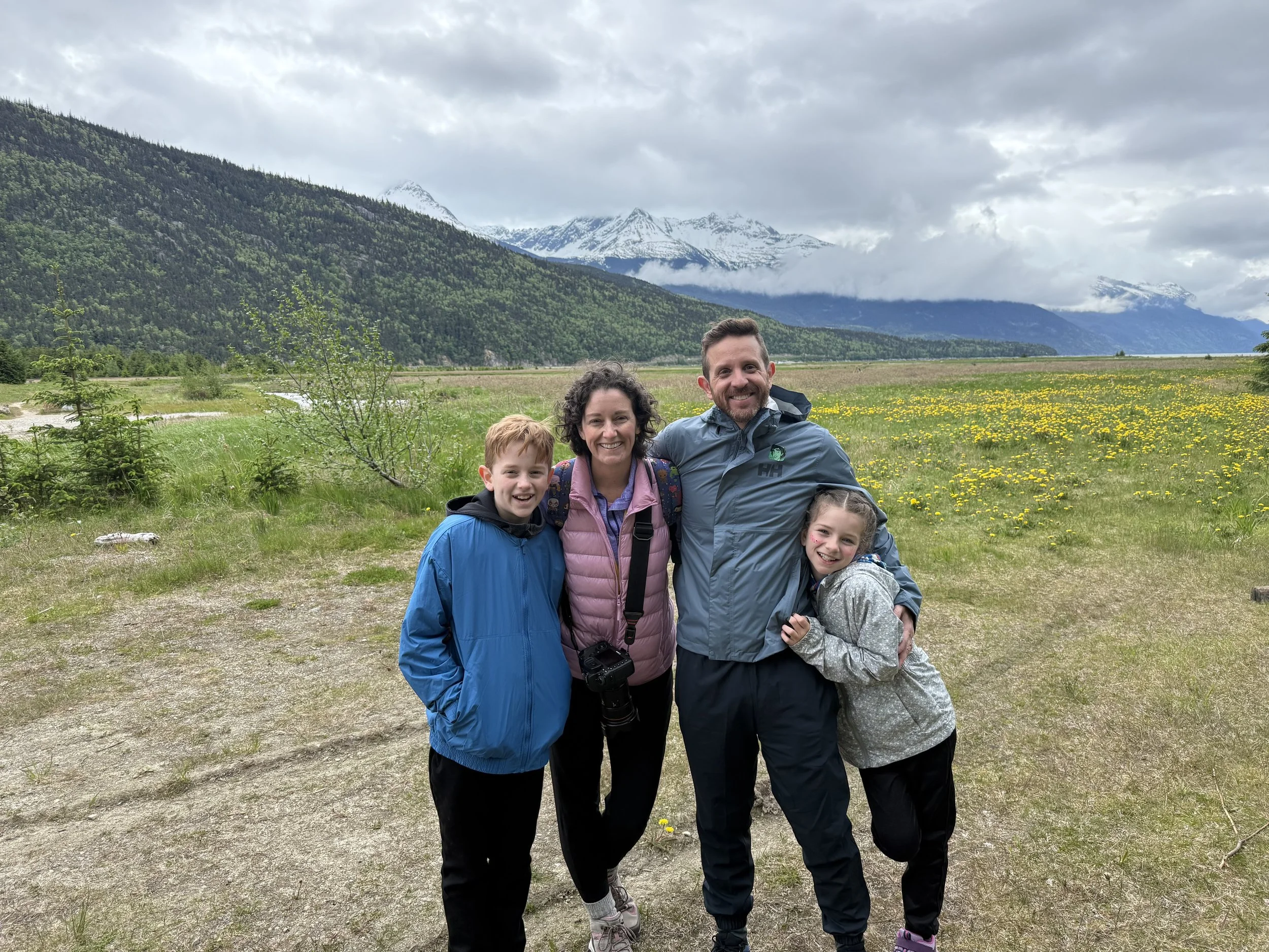 Family poses for a photo in the mountains in Skagway, Alaska.