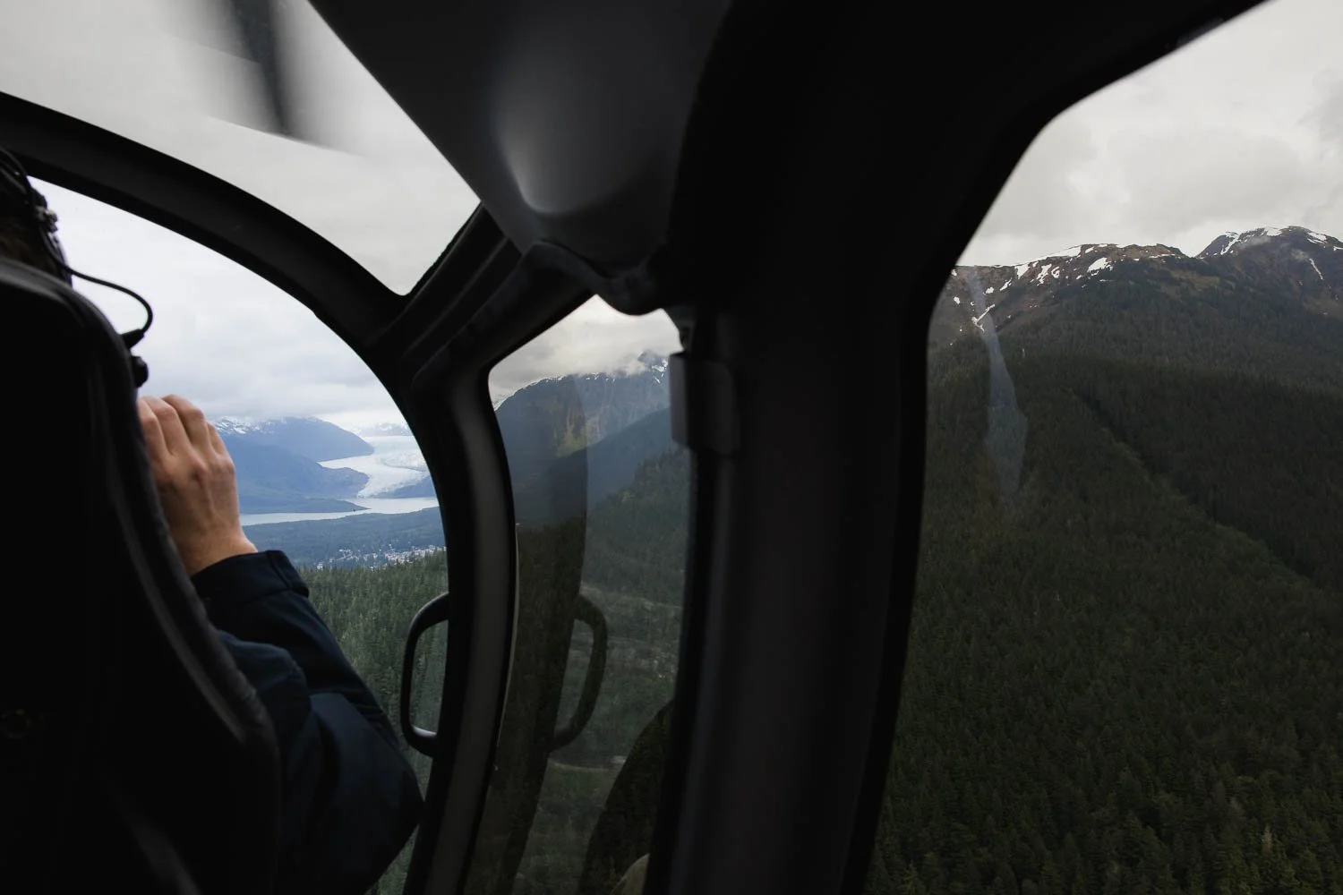 Looking out a helicopter at Alaskan views.