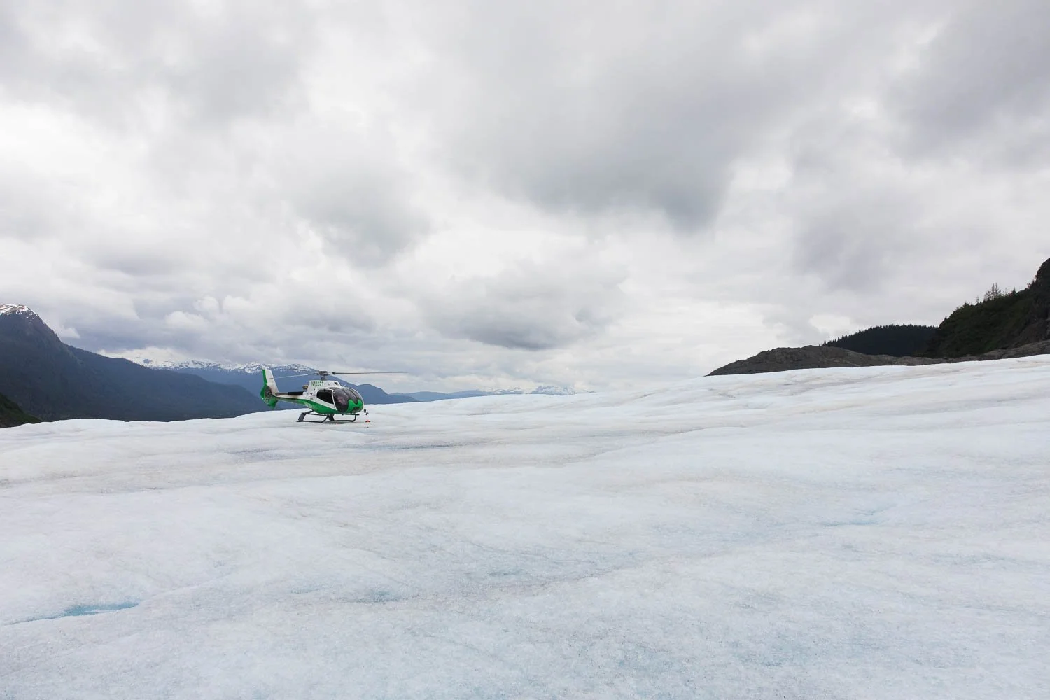 Helicopter lands on top of Mendenhall Glacier.