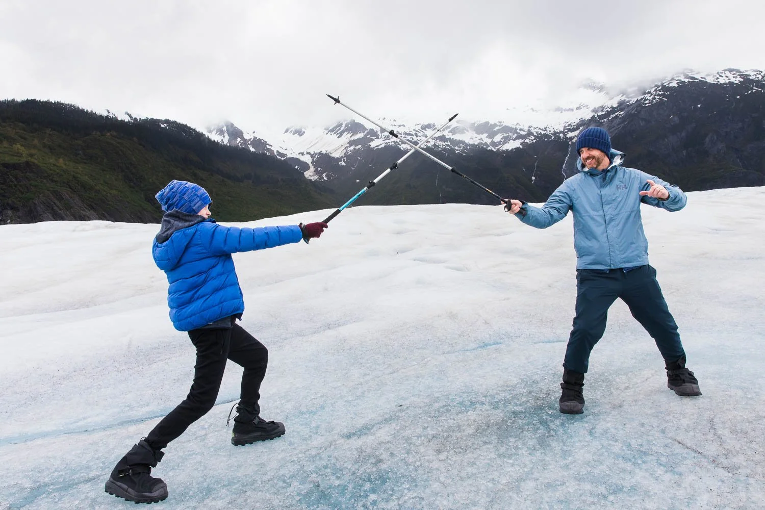Father and son have a duel with their walking sticks on Mendenhall Glacier.