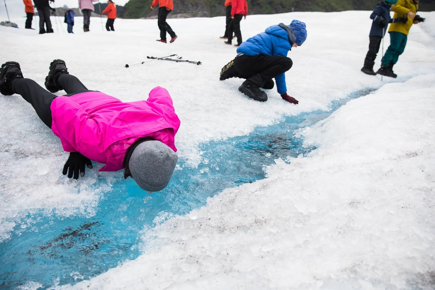 Tourists drink the glacier water in Alaska.