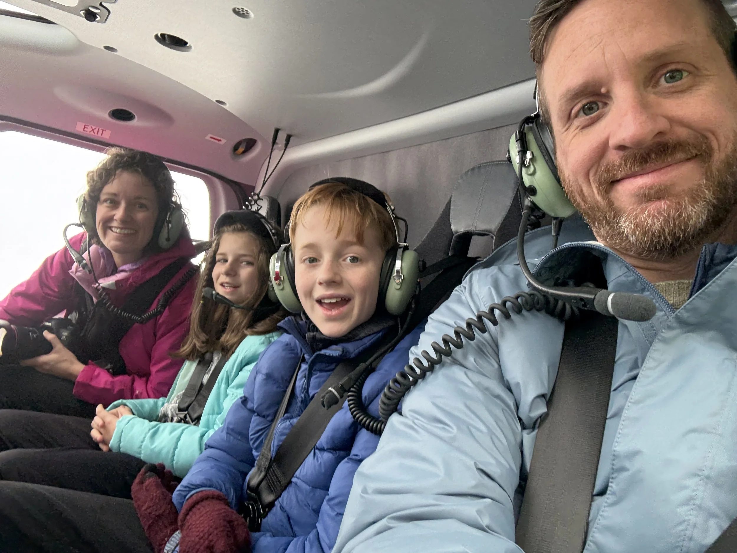 Family selfie on a helicopter tour in Alaska.