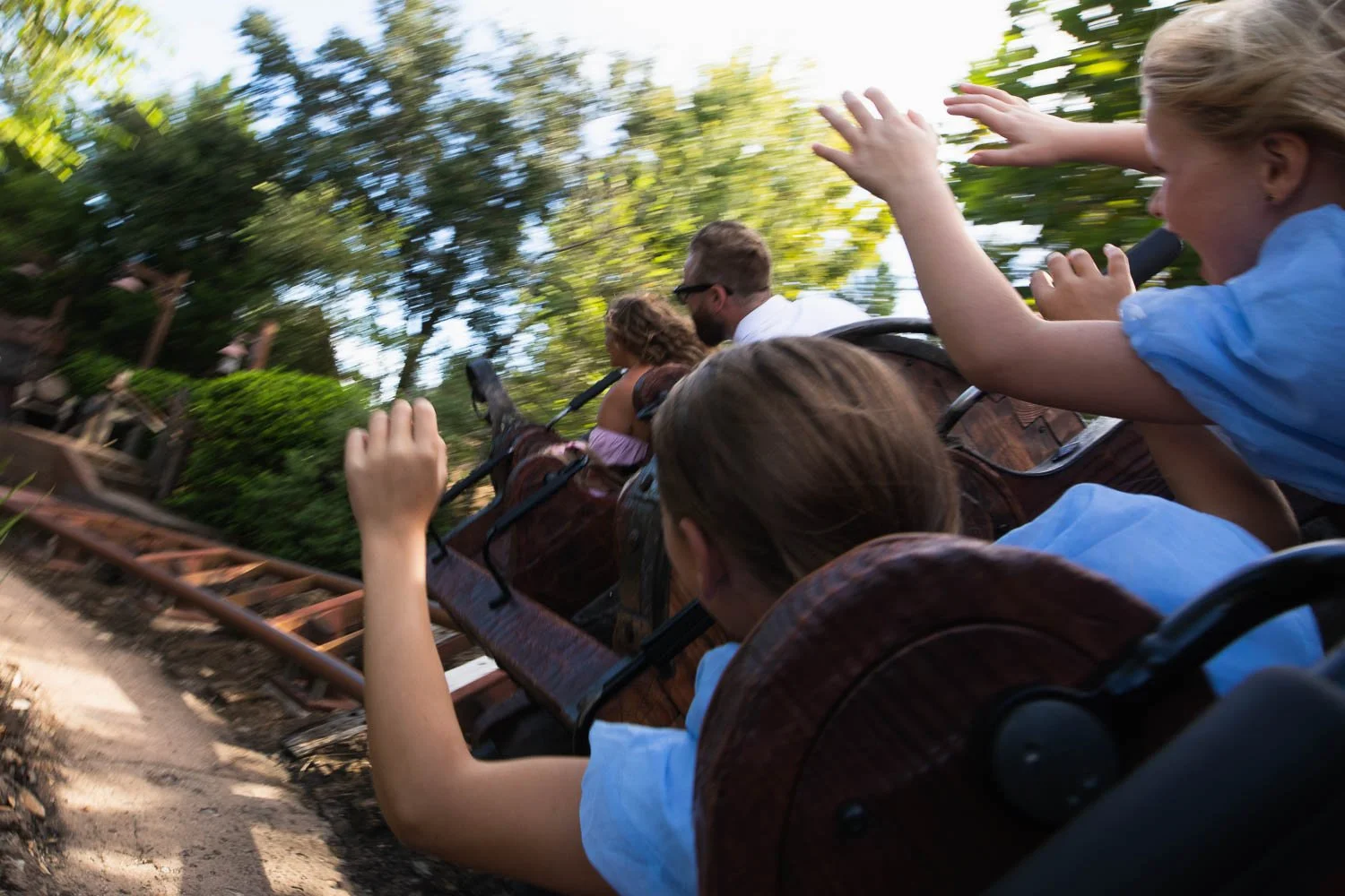 Girls ride Seven Dwarfs Mine train at Magic Kingdom.