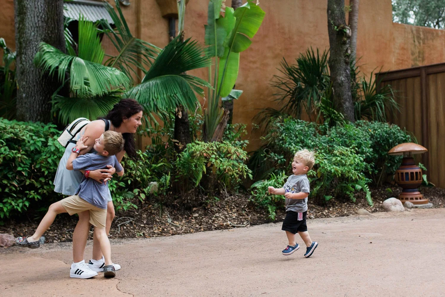 Boys run towards their mom at the Animal Kingdom.