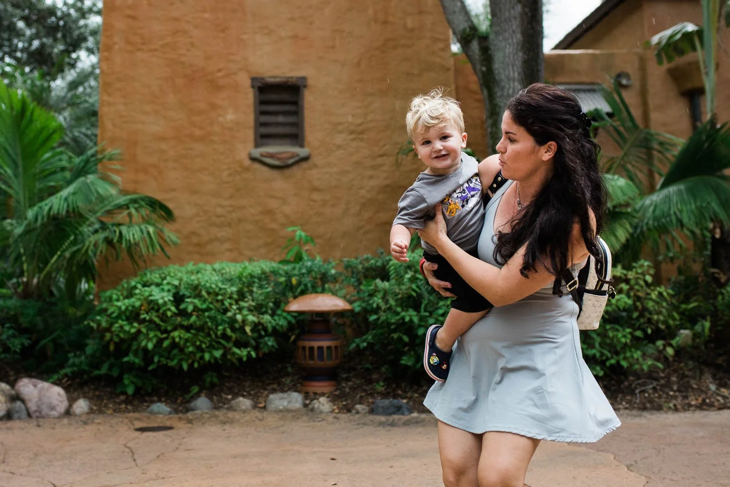 Mother and son walk through the animal Kingdom theme park.