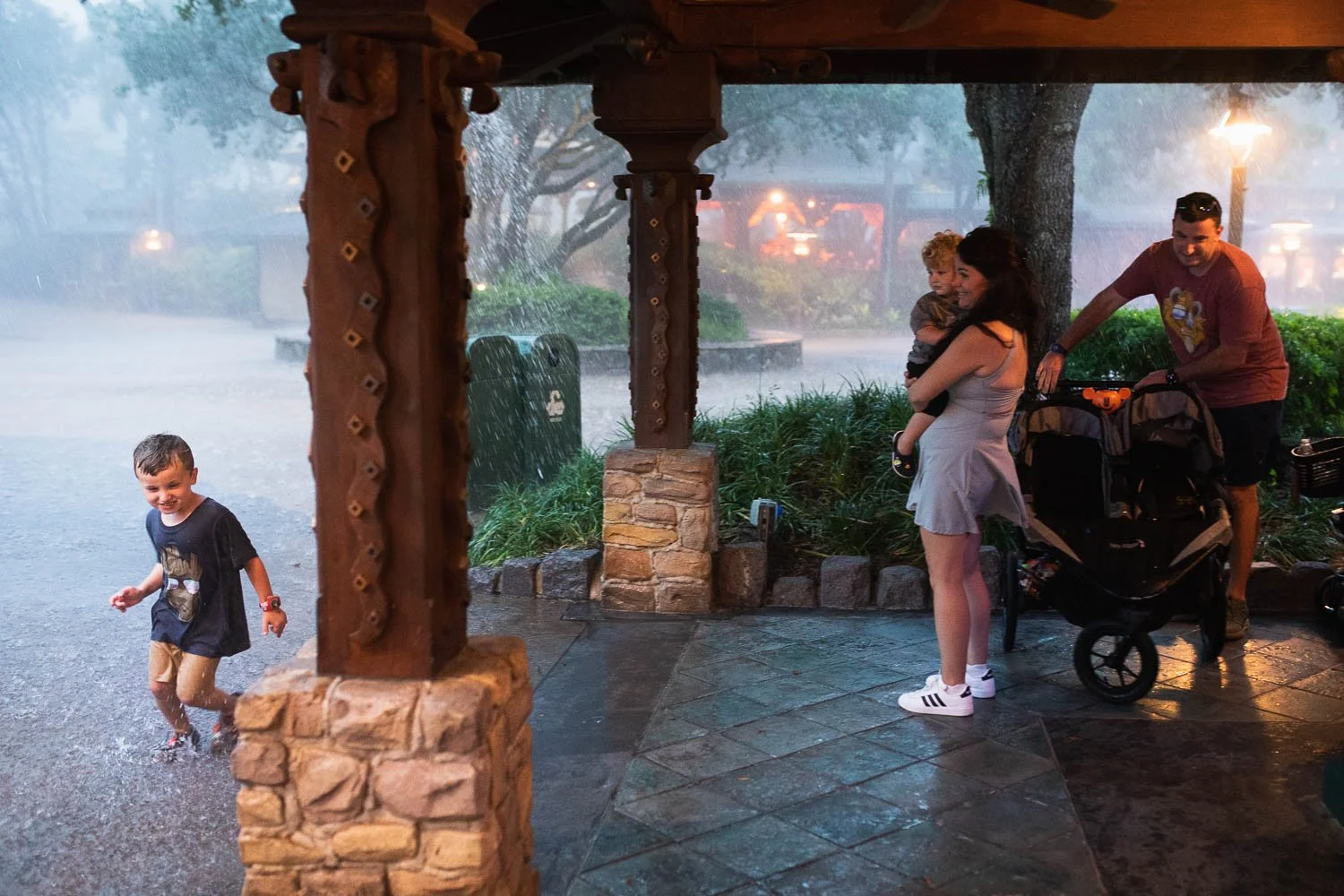 Family gets caught in the pouring rain at Animal Kingdom park.
