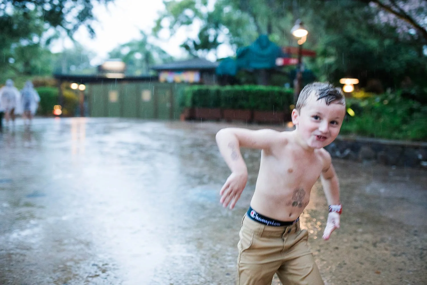 Boy plays in the rain at the Animal Kingdom.
