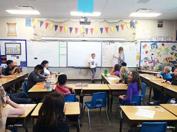 In Jude's classroom they get to ask Jude ten questions. These questions are things they might not have known about Jude. Miss. Seamons is writing the answers on the board. 