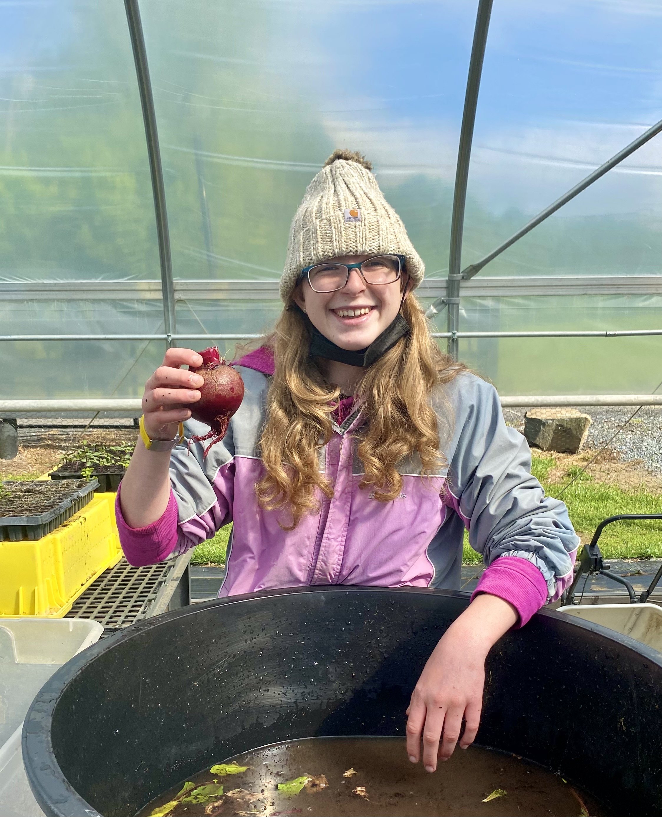 Grower Emma washing beets in the greenhouse.jpg