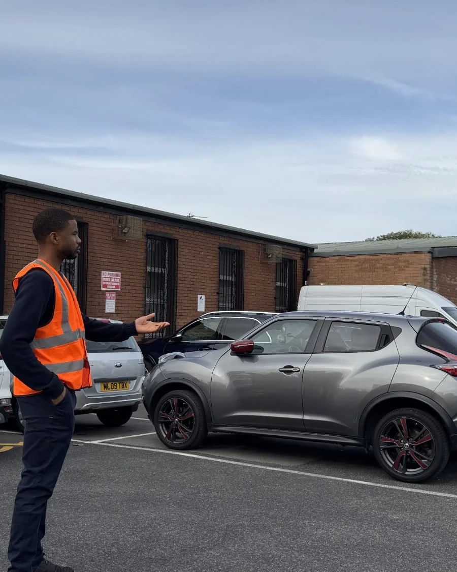 A car park steward in a high-visibility vest