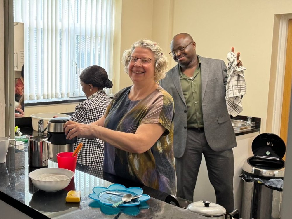 Volunteers serving refreshments in the church kitchen