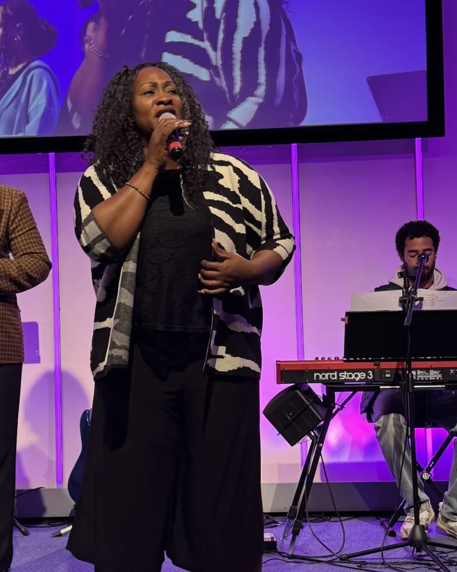 A vocalist singing with the worship team